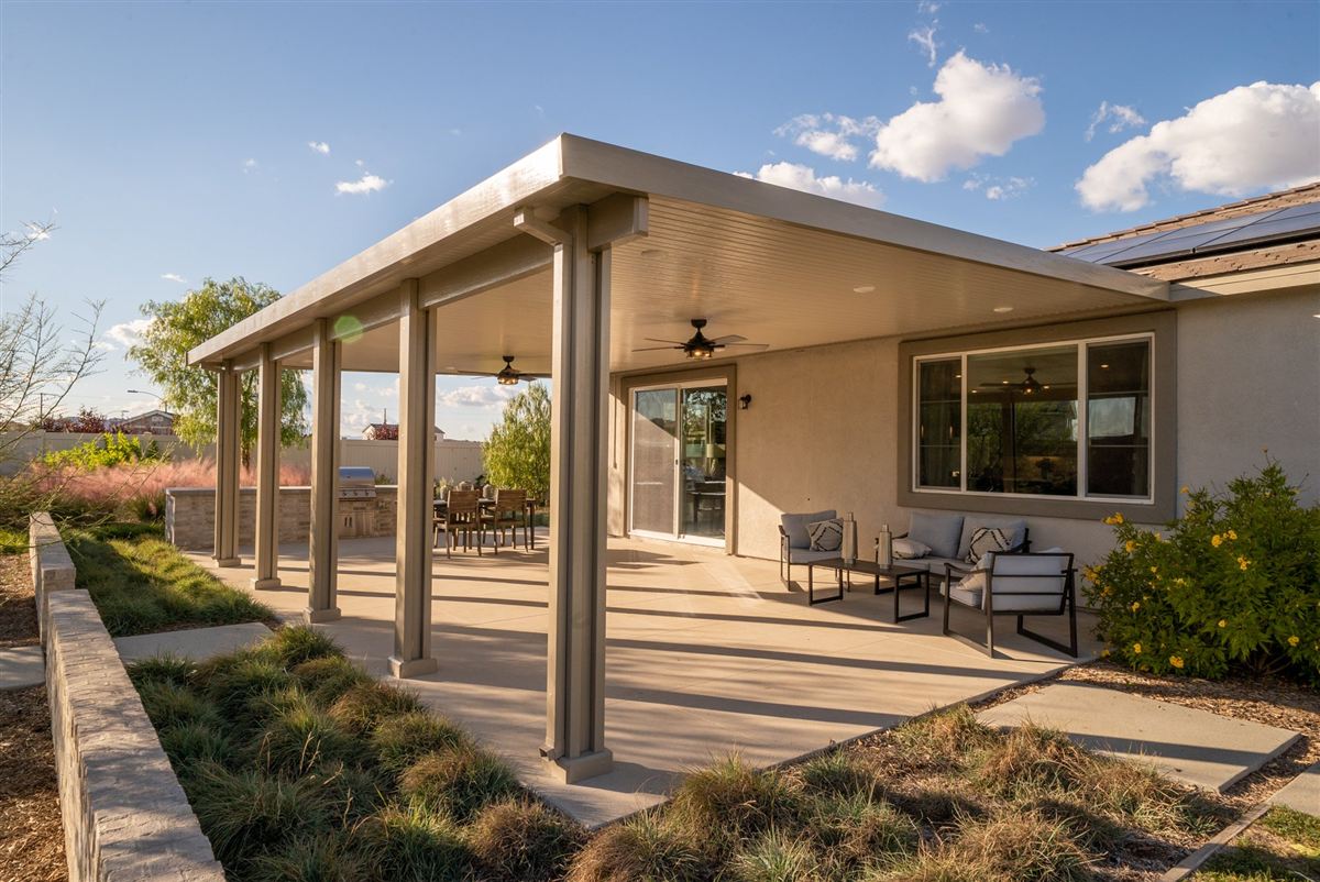 Aluminum patio cover shading a backyard patio