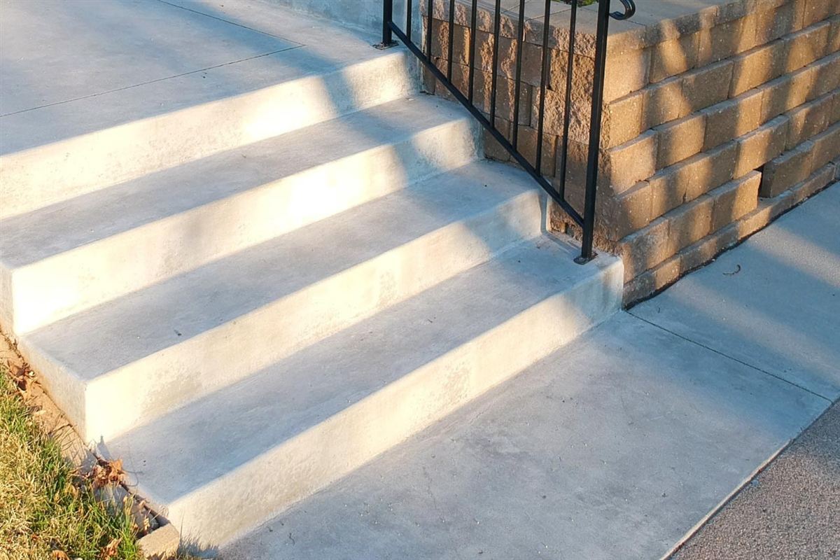 Gray concrete stairs built into a landscaped yard