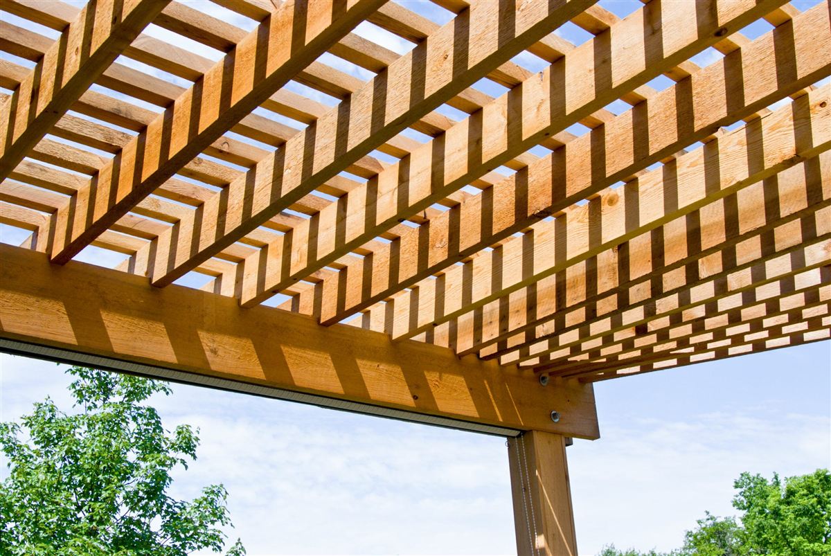 Wooden pergola shading an outdoor seating area