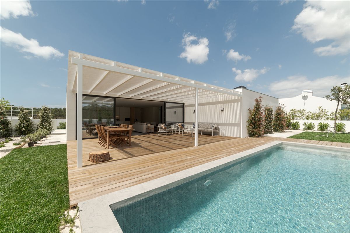 Modern house with a garden, swimming pool, and wooden pergola