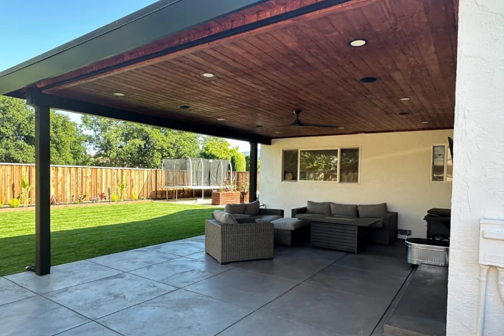 Covered patio beneath a solid roof patio cover
